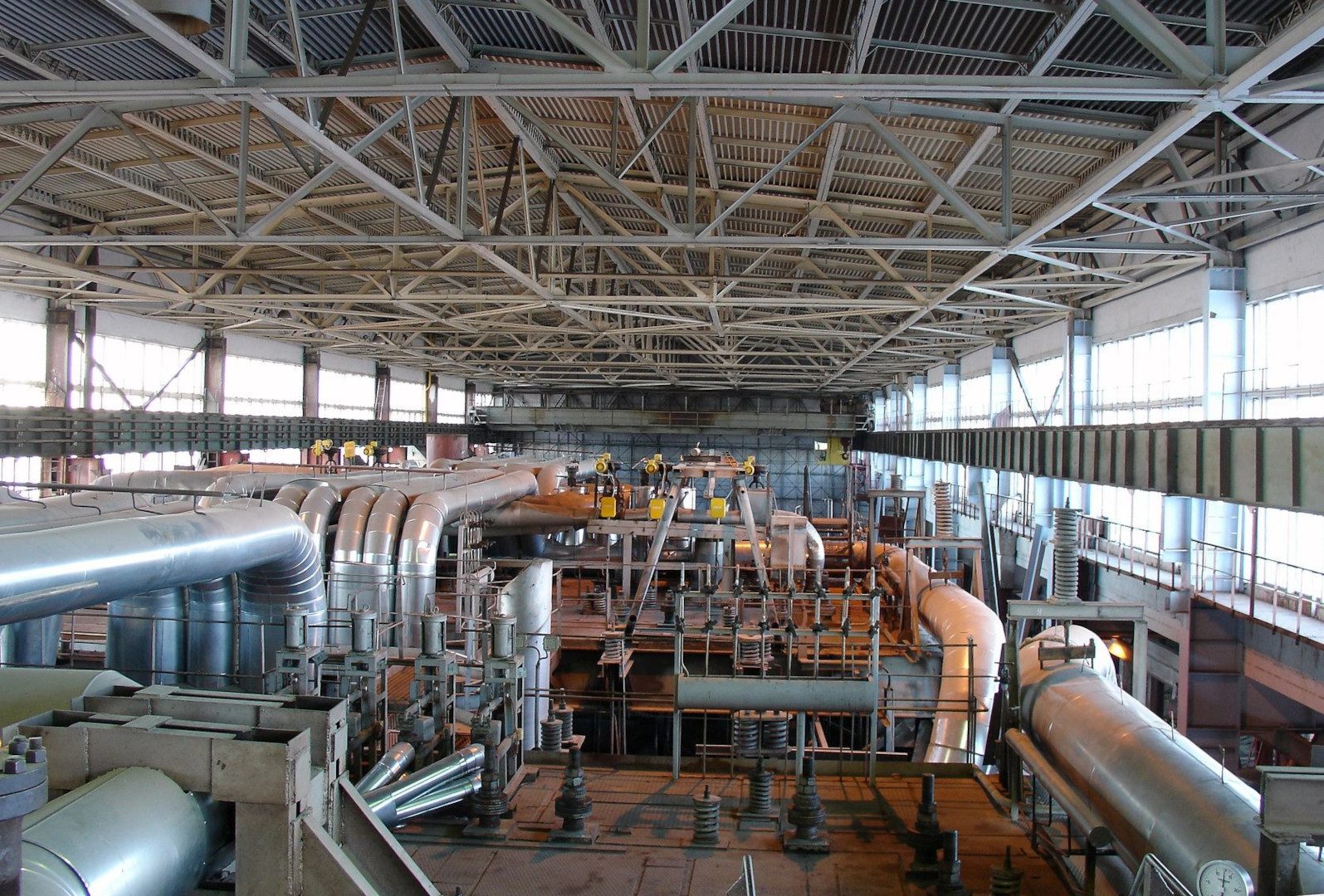 A large warehouse with many pipes and other equipment.